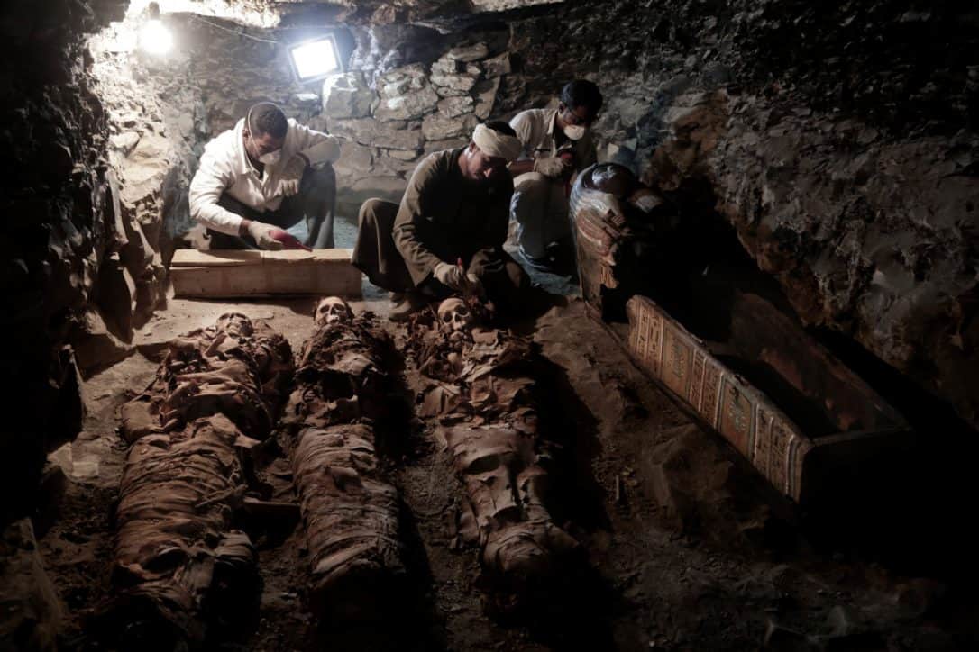 Workers cleaning up the mummies in the new tomb